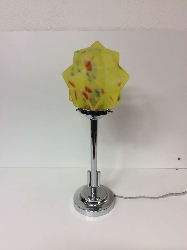 An Art Deco Table Lamp, modernist chrome base and column with stunning Yellow multi colored glass star shade