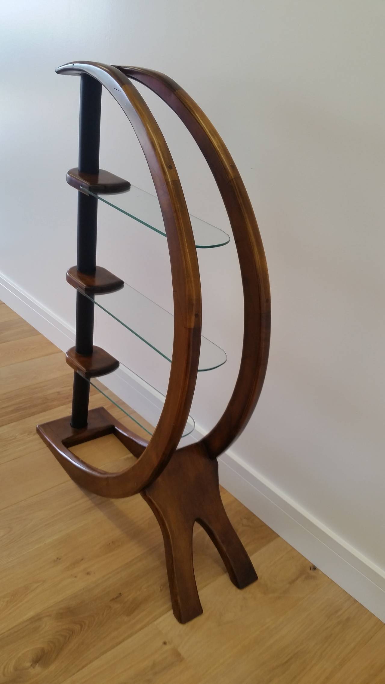 Mid-Century design freestanding adjustable shelving. 
Mid-20th century design at its best, this is a superb half-moon adjustable shelving, each of the three glass shelves can be angled to suite you, fabulous style to the angles curves yet remains