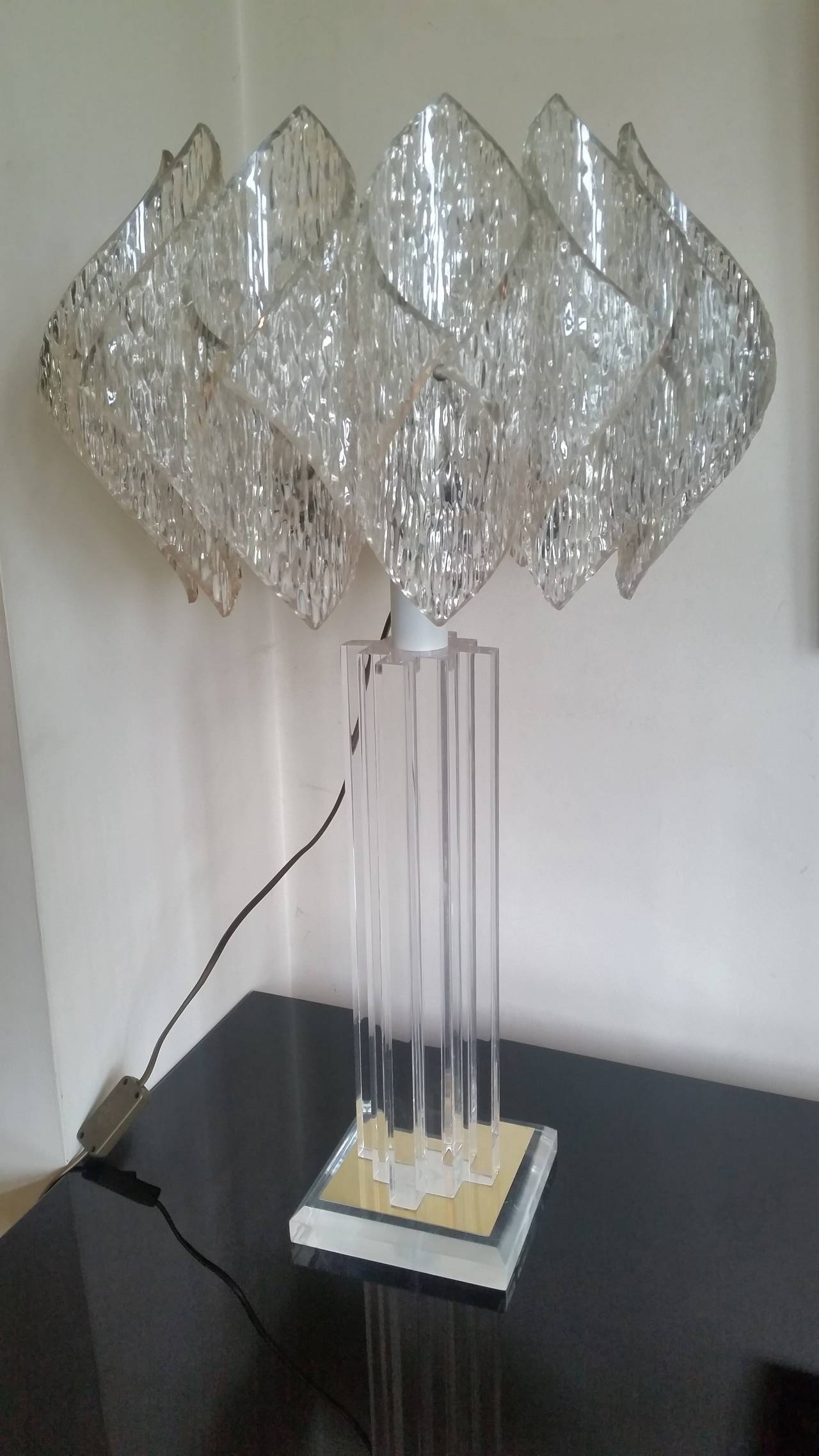 Mid-Century large Lucite table lamp. 
A fabulous mid-20th century design table lamp, the Lucite base has a brass mirror like plate the column is made up with stepped section Lucite, the shade is a wonderful acrylic lotus design, 
70 cm H 42-42 cm at