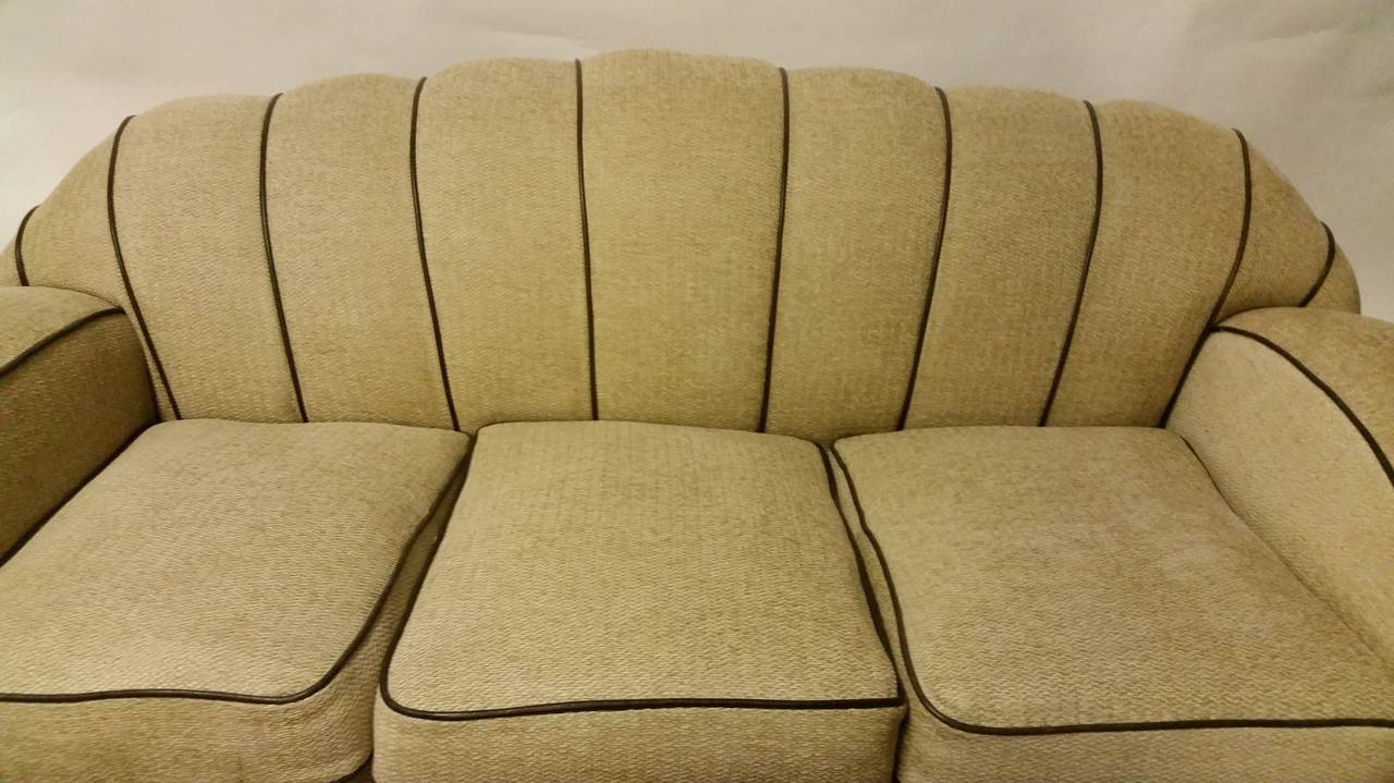 An awesome Art Deco sofa.
We have had this fabulous sofa reupholstered in a light tweed with brown leather piping and it looks marvelous.
This great shape is accentuated with the contrasting piping.
Dimensions: 75 cm H, 188 cm W, 95 cm D and the