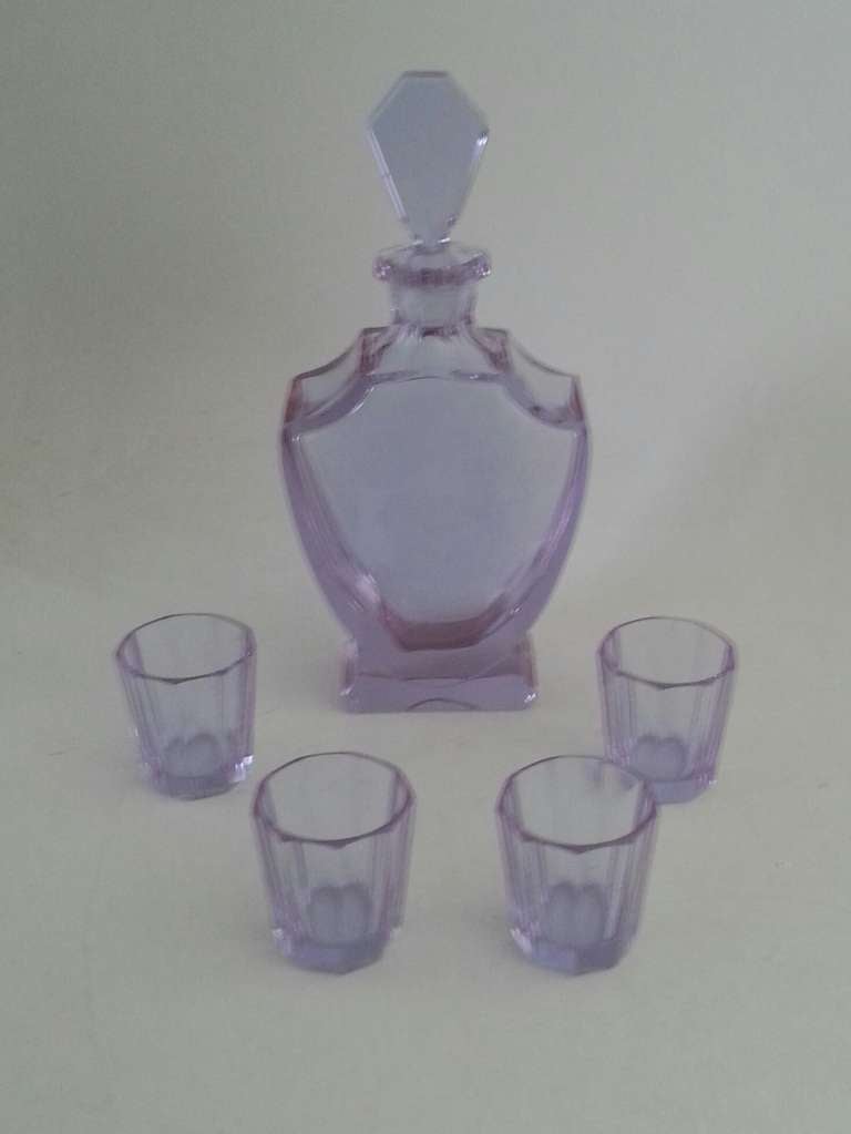 A Rare Art Deco Liquor set, Pale blue Uranium Glass turning to Mauve. 
Decanter and four faceted glasses. 
each Glass 6 cm high and 5 cm dia at the top 
Decanter 27 cm high 12.5 cm w 5.5 cm d