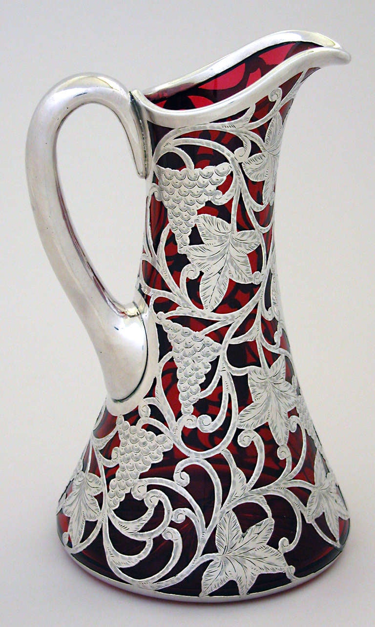 Beautifully worked red crystal with pure silver 999/1000 overlay pitcher with grapes and leaves, American Circa 1900.  9.50 in. high X 5.50 in. diameter