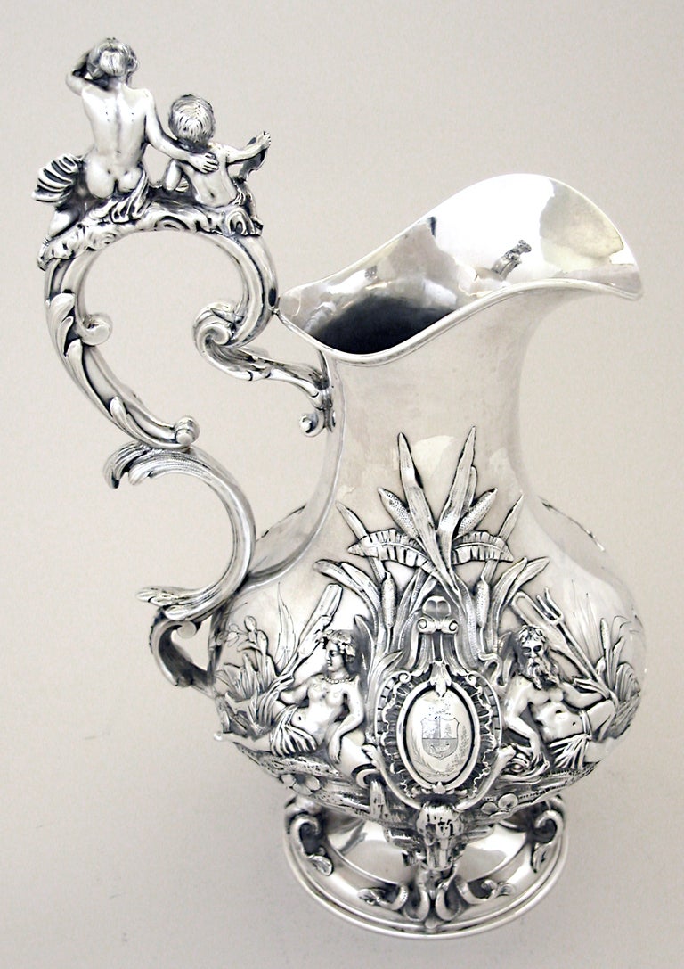 French pitcher by Émile Hugo, in the Baroque style, with fantasy nautical images of mermaids, mermen and children.  The Minerva, located at right of handle at top of pitcher, denotes 950/1000.  The top French silver content.  The weight is 58 oz. 