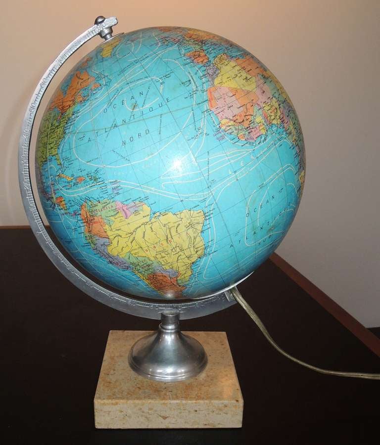 French illuminated terrestrial globe on a creamy marble base by Carte Taride. In great condition, not bits missing, so when lit, it reads well, casting a warm, pleasing light.