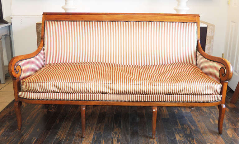 French walnut Canape from the Restoration Period, ca. 1830. The light walnut wood, lovely closed-scroll arm and leg details dovetail with the Biedermeier style popular at the same time in the rest of Europe. Wood in excellent condition. A matching