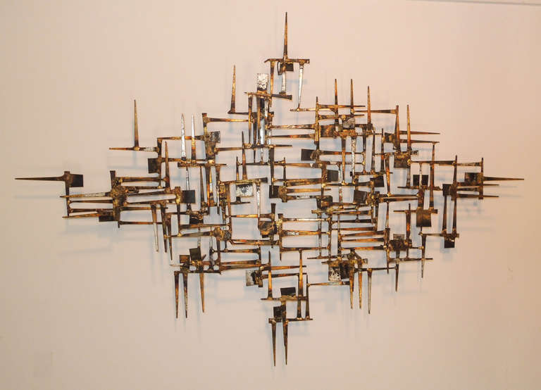 Nail sculpture by William Bowie which can hang horizontally or vertically.