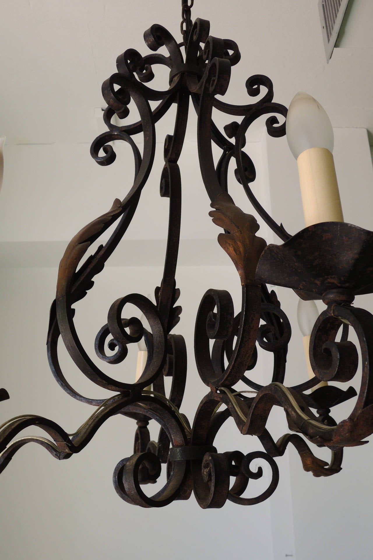 Classic French chandelier. Iron with acanthus leaves in faux bronze patina.
Iron his hard to date, but this one looks to be between the wars.