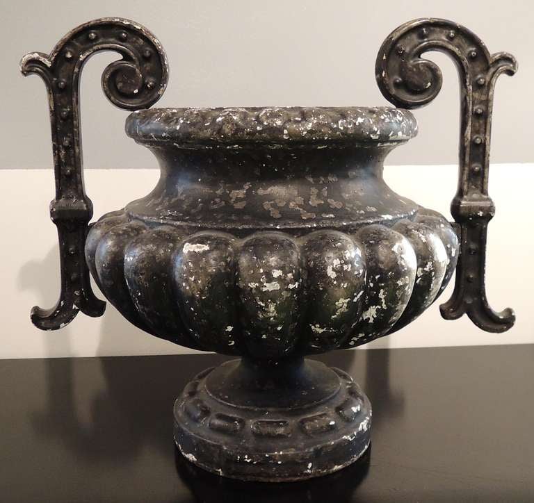 Classic French enameled urn, late 19th C. Black enamel beautifully worn and patinated. Two graceful handles with studded decoration. Generous, sensual body sits on a slender, sexy foot.