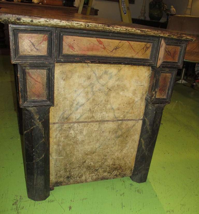 Great desk with beautiful cherry top and Gothic column legs, faux marble sides. May have been used in a church. there are two coin slots at one end, above a drawer with a lock...a coin drop for candle votive donations? Three drawers in back, with