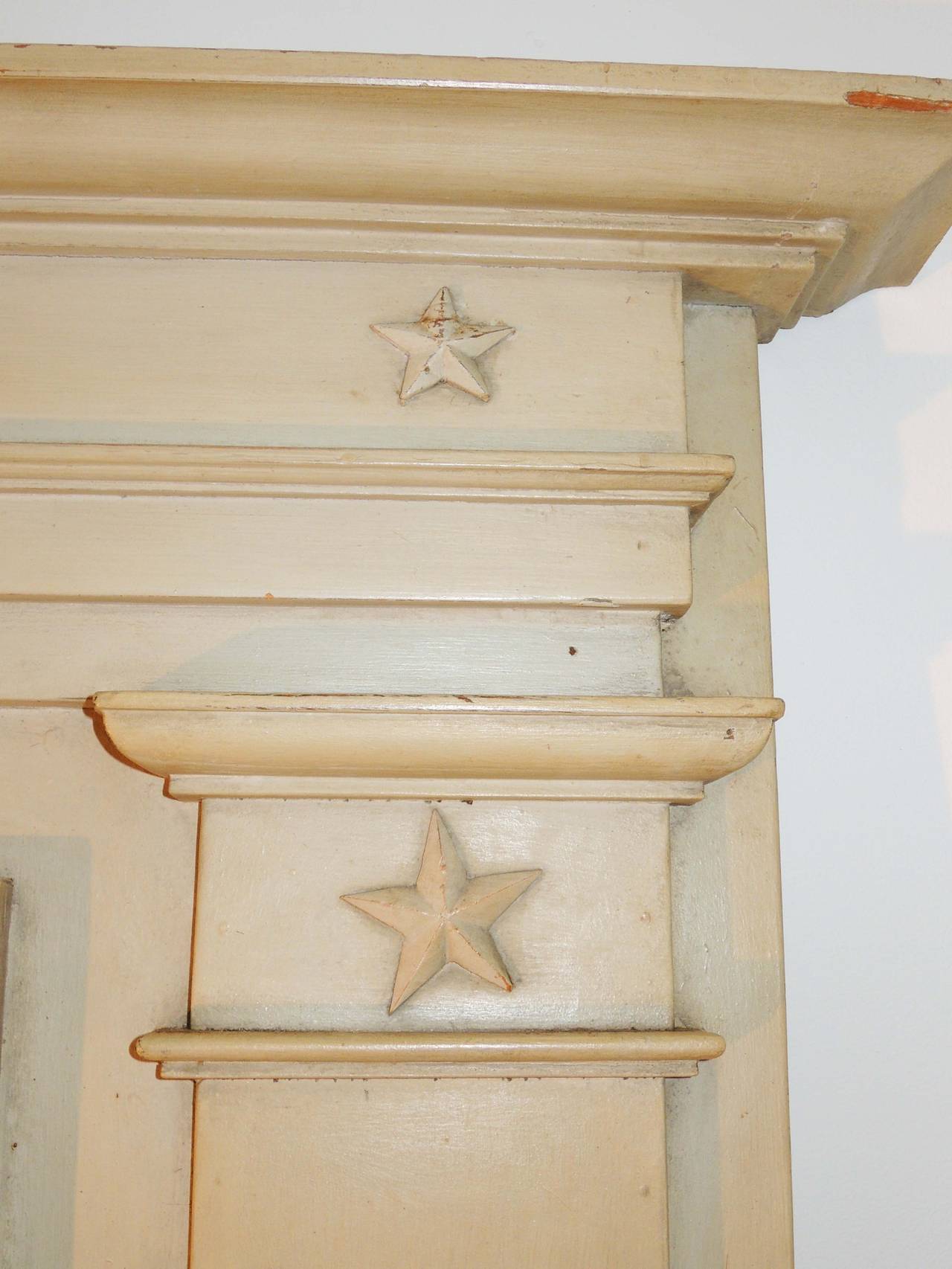 Original paint, decorative brass accents of angels and birds on the sides, carved wooden stars adorn the top. Bottom glass is original. Top glass replaced at some point with old mirror. All moldings, trim, etc. solidly in place. Good thickness and