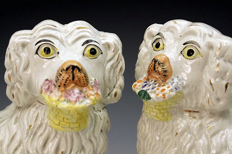 English Pair Staffordshire Pottery Figures Of Dogs With Baskets 