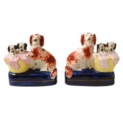 Pair Staffordshire pottery dogs with pups in basket with blankets c1850 