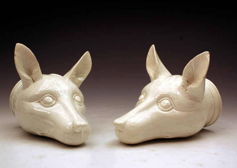 A striking pair of Staffordshire pottery fox head stirrup cups with a pearlware glaze.
These stirrup cups are rare figures and a pair in this condition is a wonderful bonus. 