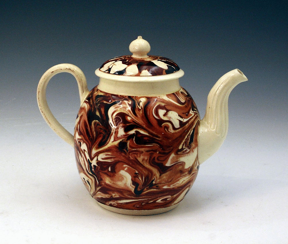 Early English pottery surface decorated creamware teapot in mocha colors 