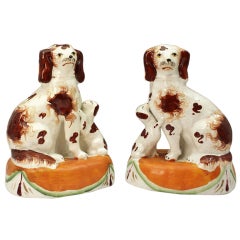 Pair Staffordshire Pottery Figures Of Spaniels On Drape Bases 