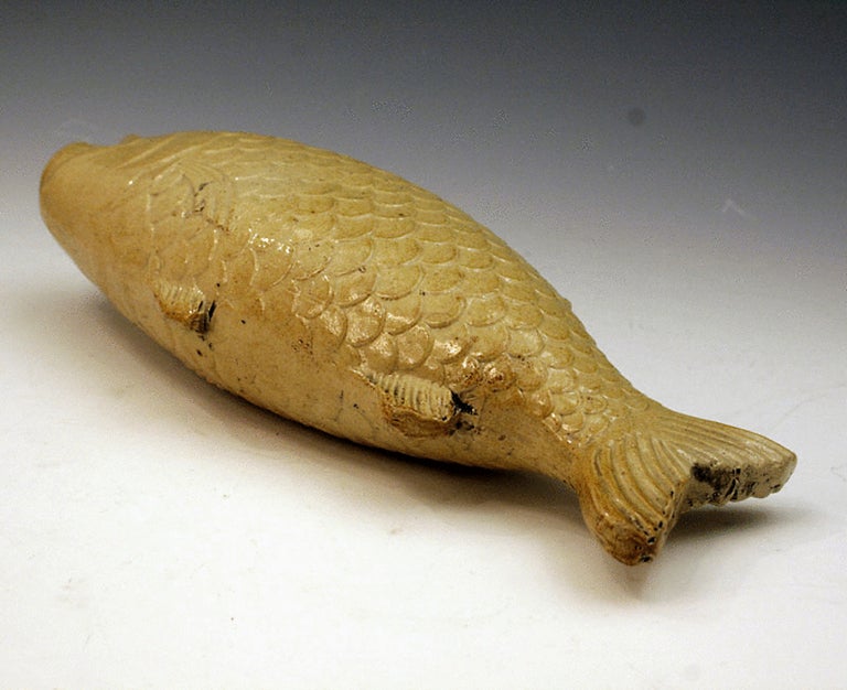Antique English brown stoneware flask in the form of a fish. 
The flask is a light buff colour,relief moulded and finished with a saltglaze. 
It is Derbyshire or London manufacture. A similar piece of slightly different form was impressed with the