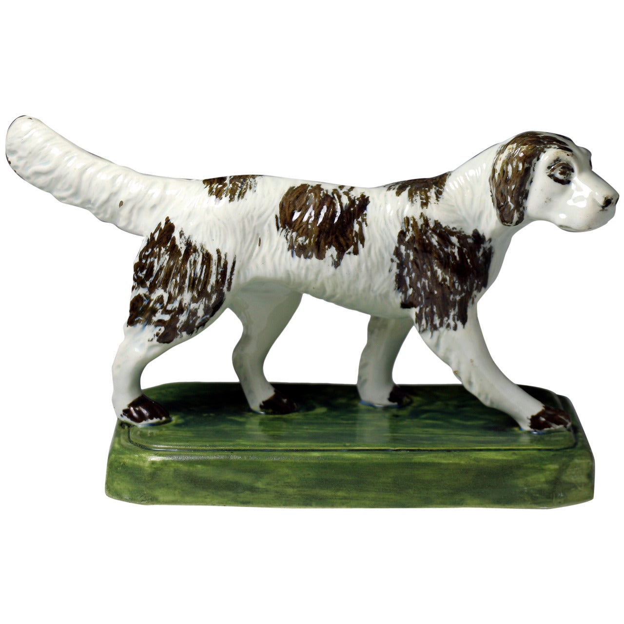 Antique pottery figure of a setter dog standing on a base
