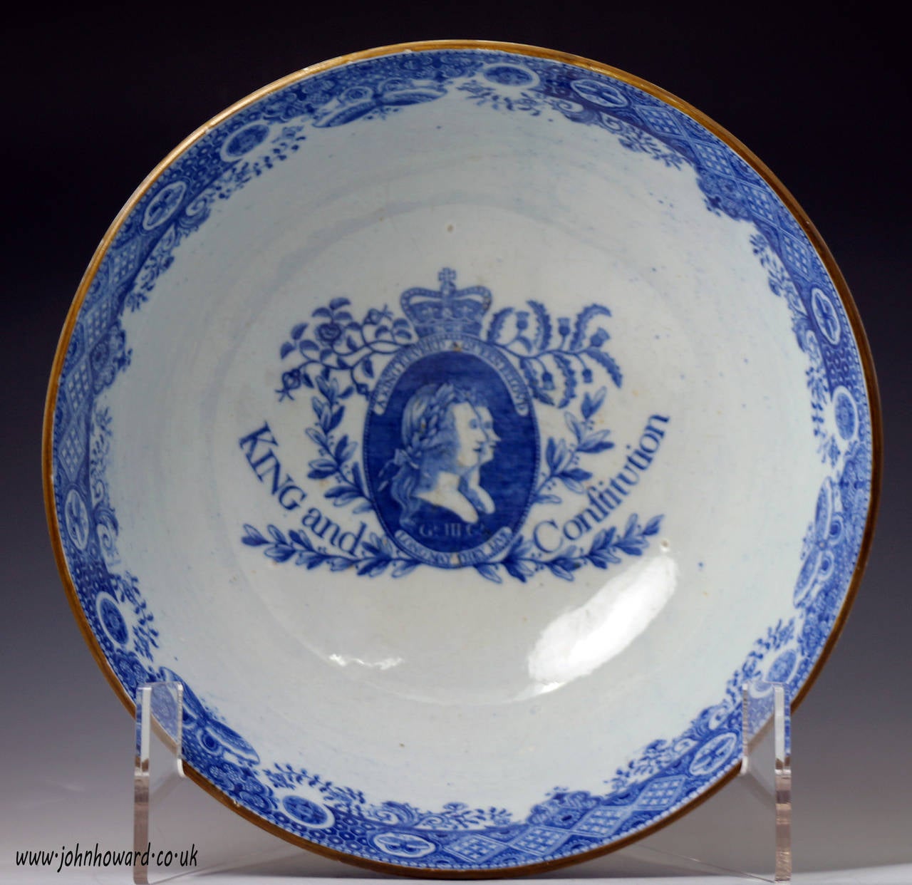 A fine pearlware pottery bowl commemorating King and Constitution with underglaze blue and white transfer prints of King George 111 and his Queen. The portraits are encircled with the script 