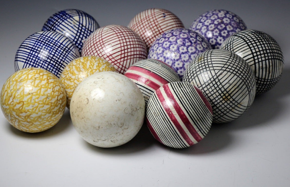 A set of antique pottery carpet balls with sponged decoration in various colors. 
The collection comprises of 6 pairs and the illusive and rare white 