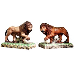 Pair  of antique English pottery lions on bases Staffordshire Pottery.