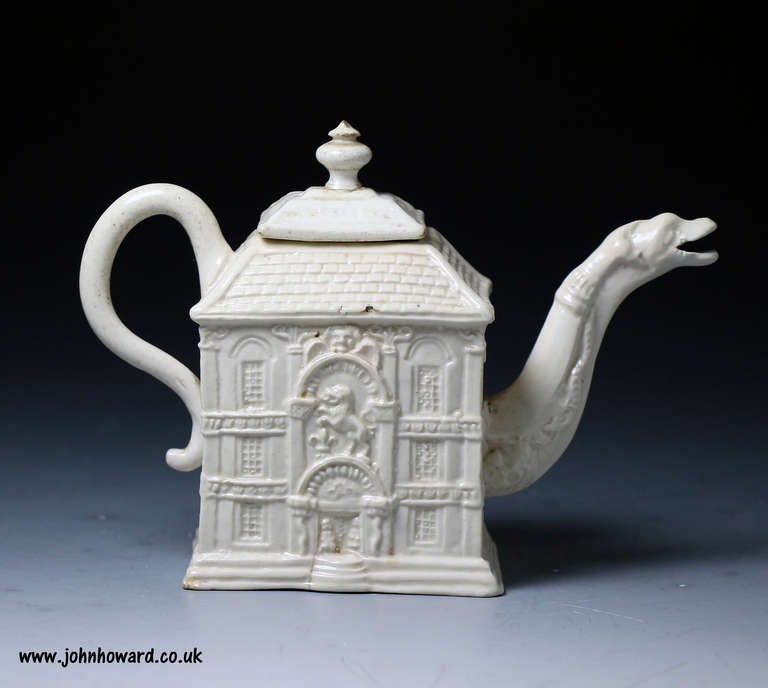 Antique Staffordshire pottery stoneware teapot.
This early example is made in the form of a country house with a relief molding technique.
The spout of the teapot is modelled with a figure of a fanciful serpents head.