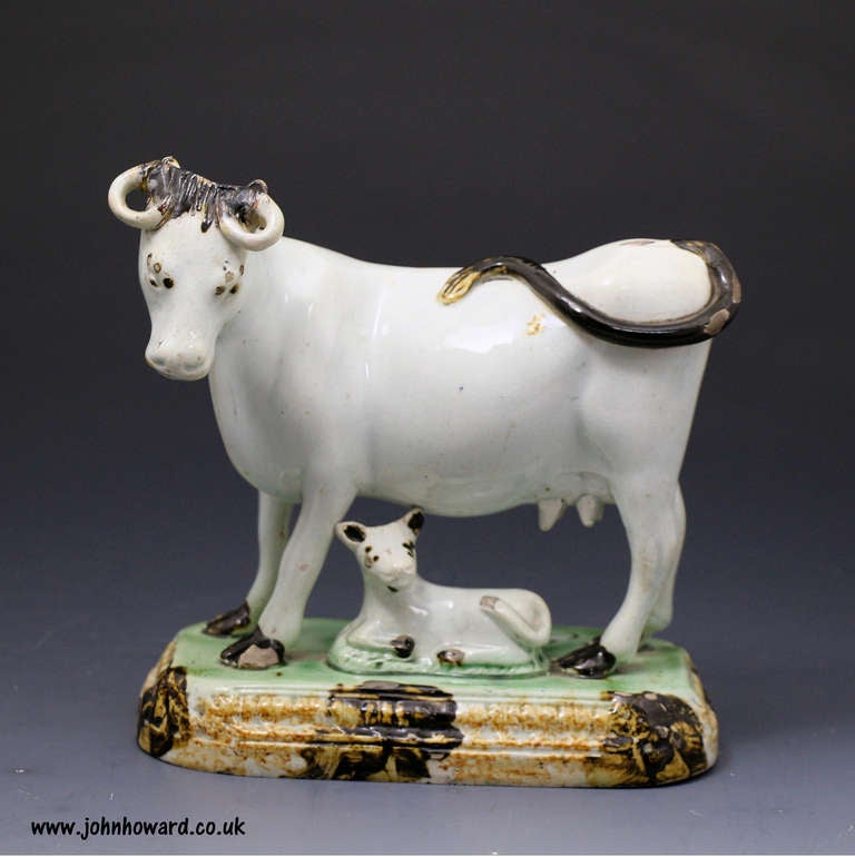 Antique English Yorkshire pottery of a cow modelled standing on base. An unusual and very rare feature of the figure is the name Fanny written in script on the base.
Underglaze Prattware colors with classic Yorkshire modelling of the figure.