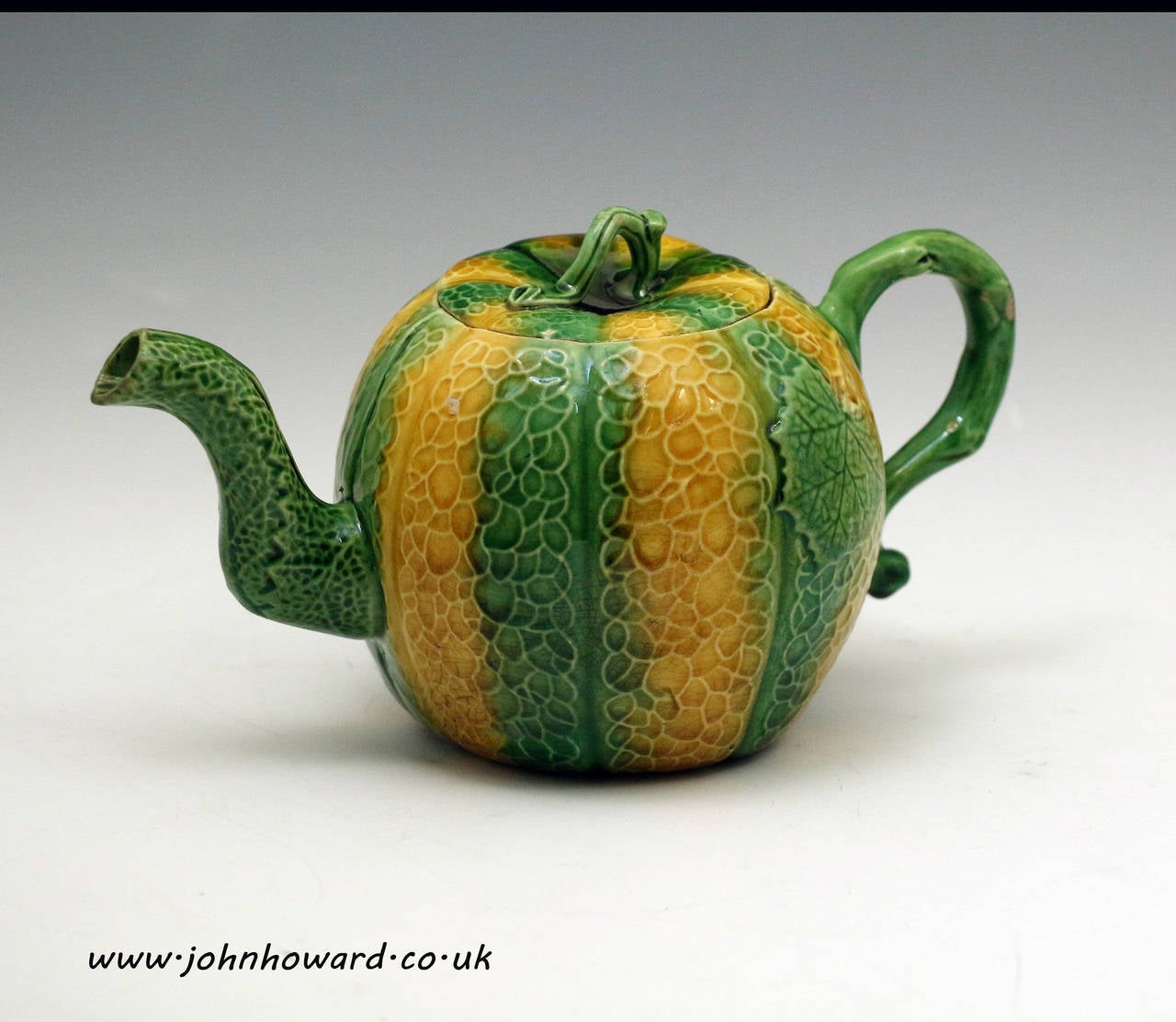 An exceptionally rare melon shaped Staffordshire pottery teapot with coloured oxide lead glaze over a finely potted creamware type body. 
This exquisite pots diminutive size reflects the expensiveness of tea in the mid 18th century.