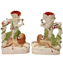 Pair of Victorian Staffordshire pottery figures of lions with cubs.