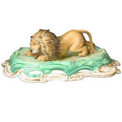 Antique English porcelain figure of a crouching lion