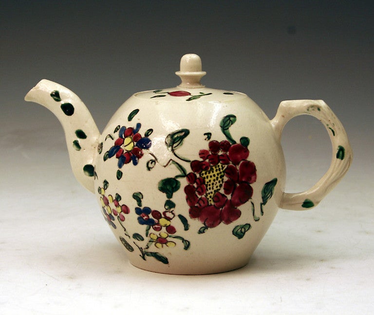 Early Staffordshire stoneware salt glazed teapot with floral decoration in strong enamel colours.

Staffordshire. 