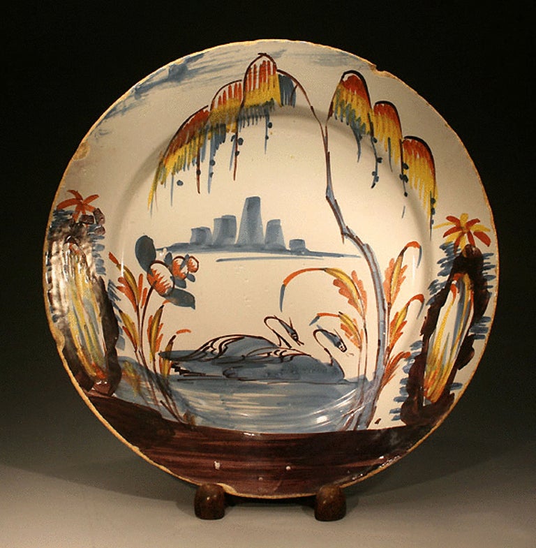 Antique English pottery polychrome delftware dish strikingly decorated with two swans. Liverpool or Bristol pottery circa 1730 period.