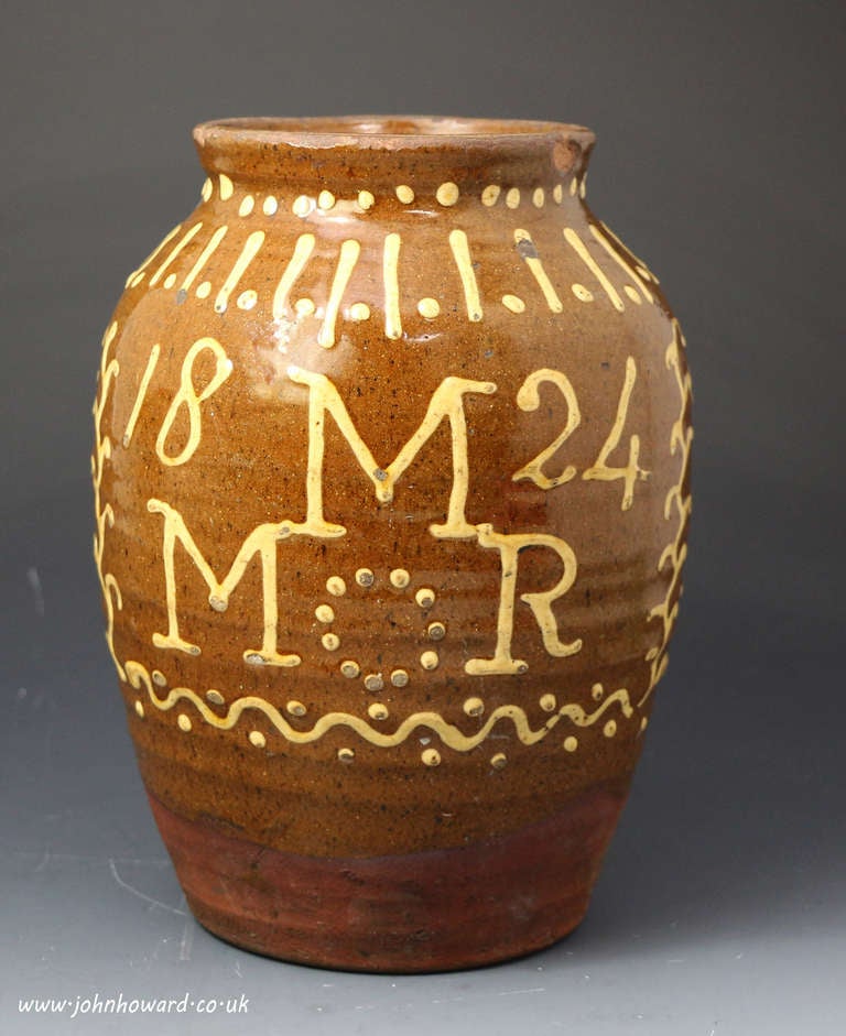 A good example of a slip decorated earthenware jar with the initials MMR and the date 1824.
The slip decoration is applied profusely all over the jar which renders it a very decorative and interesting piece of pottery.
It is possible that the jar