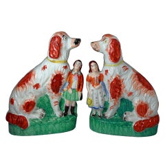 Pair of antique Staffordshire Pottery Victorian Afghan dogs with children 