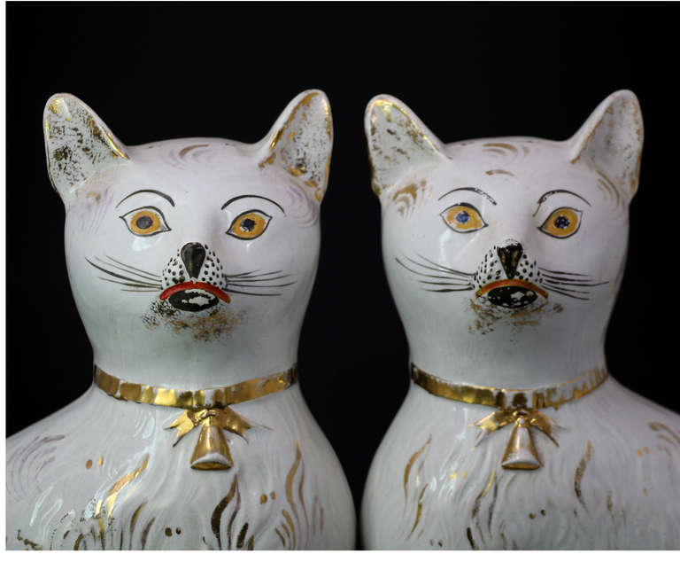 A very good pair of pottery figures of seated white cats with gilt decoration to their collars and coats.
Scottish pottery.
One of the best pairs of these felines full of character and charm. 

 