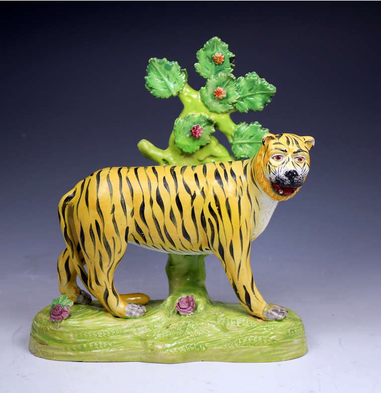 Antique Staffordshire pottery figure of a tiger with bocage from the Dale Pottery . 

A very rare antique Staffordshire pottery figure of a prowling tiger with bocage. 
The figure is well modeled with good strong enamels. Interestingly the
