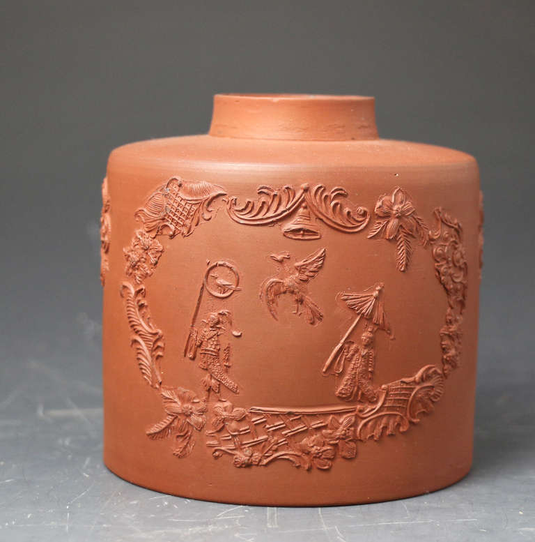A fine redware tea caddy with chinoserie sprigs. The applied sprigs are extremely fine and the caddy is a good example of redware Staffordshire pottery from the circa 1760 period.