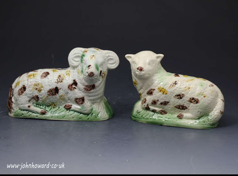 Antique pair of figures of a ewe and ram creamware bodied Yorkshire pottery c1790 

Relief molded figures with coloured oxide decoartion underglaze.
A naive and charming couple.