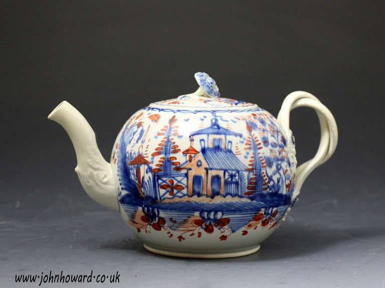 Antique creamware pottery teapot decorated in the chinoserie style much in vogue in the late 18th century.
The teapot is decorated in painted blue and red oxide colours.