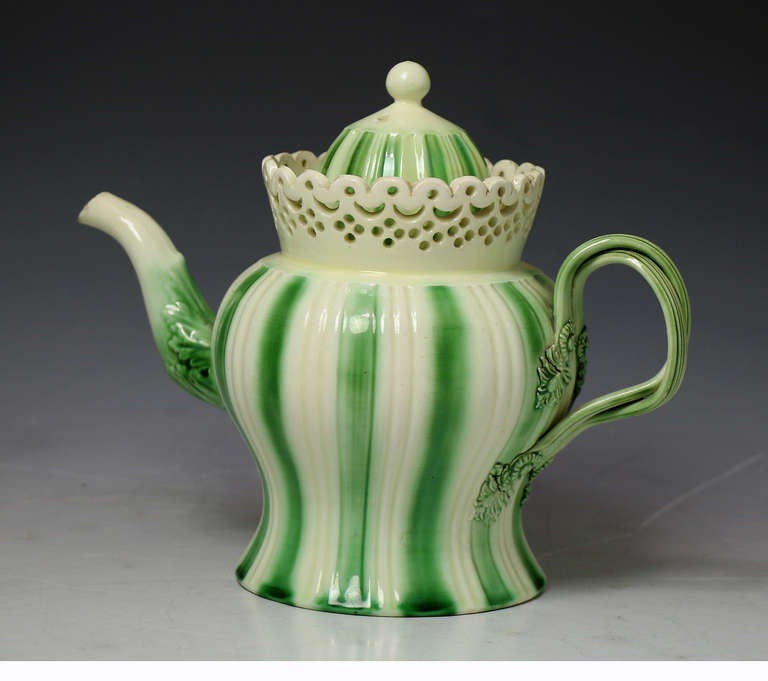 Antique period English pottery creamware teapot.
This early piece is reticulated and enhanced with a translucent green glaze at the borders. 

Leeds Yorkshire England. 

Provenance: Tom Walford Collection.