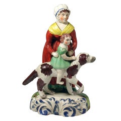 Antique Staffordshire pottery figure of a Nanny with child and dog c1820.