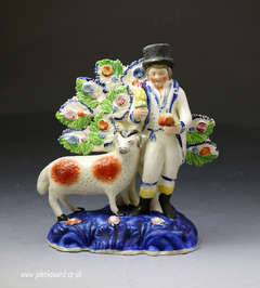 Antique Staffordshire pottery of a farmer standing by a sheep