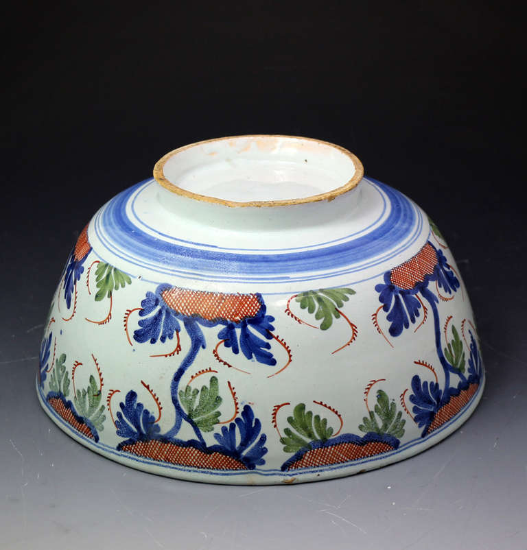 A good antique English earthenware delftware bowl decorated in polychrome colours.