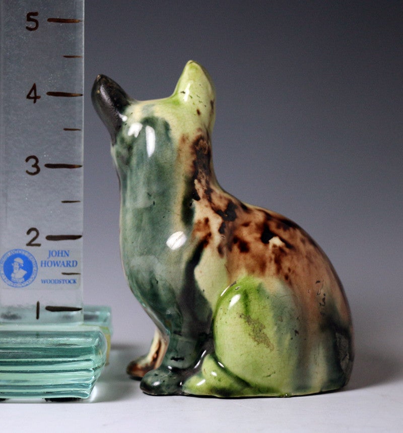Creamware pottery figure of a seated cat decorated in 