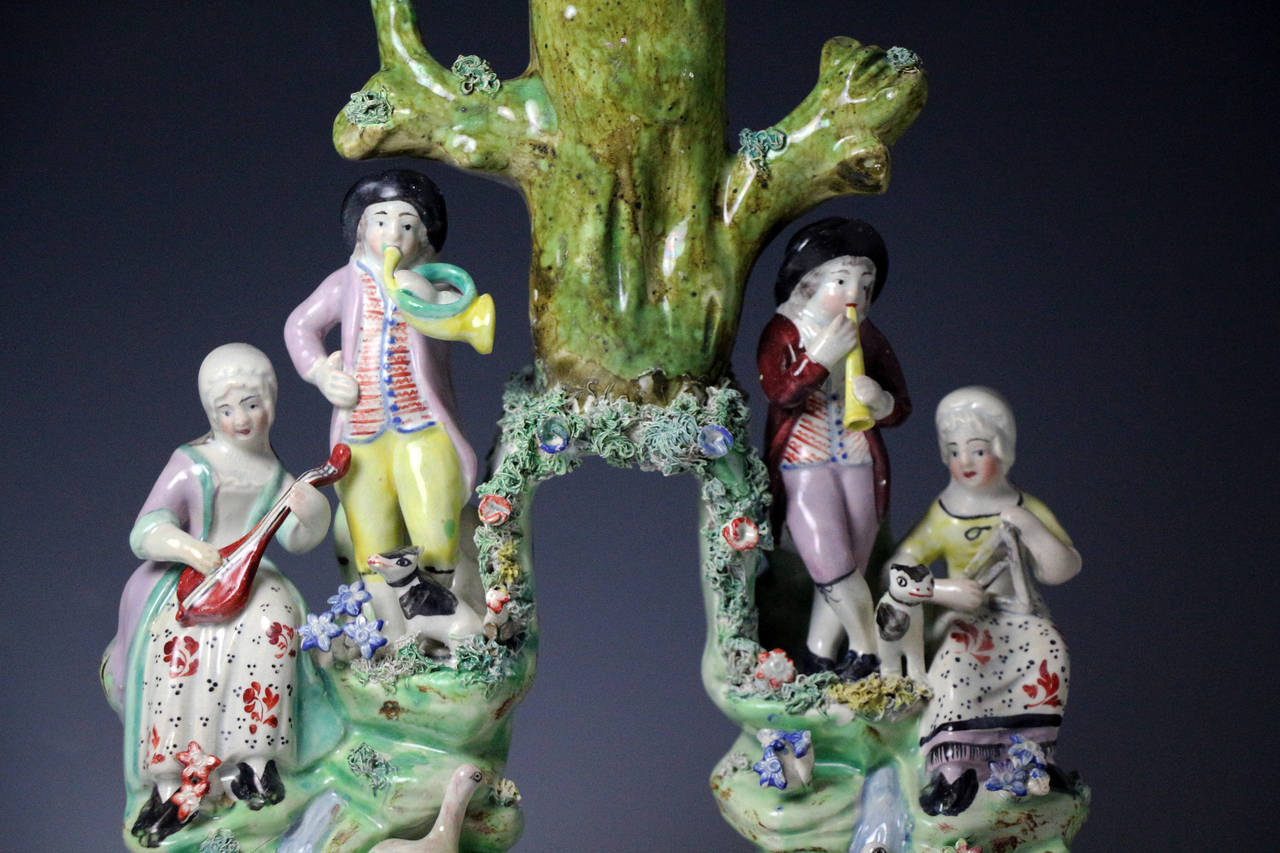A fine Staffordshire pottery figure group known as the Songsters. 
This elaborate and detailed figure is exceptionally modelled with fine enamel decoration. 
One of the most decorative and appealing figures produced from the Staffordshire potters.