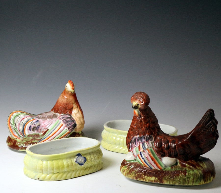 English Staffordshire pottery figures of hens on baskets with a flower motif