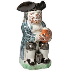 Antique Staffordshire pottery figure of a Toby Jug in colored glazes