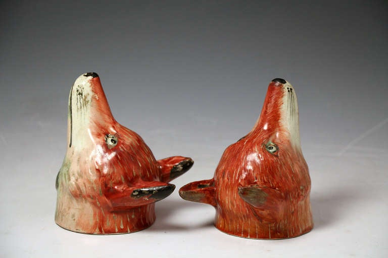 English Pair of antique figures of fox head stirrup cups, Staffordshire pottery c1820 