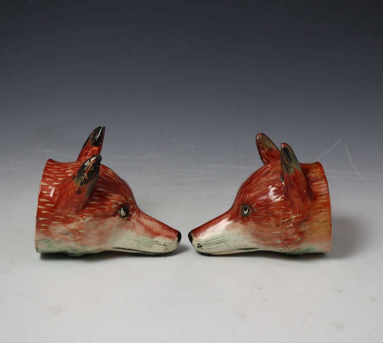 19th Century Pair of antique figures of fox head stirrup cups, Staffordshire pottery c1820