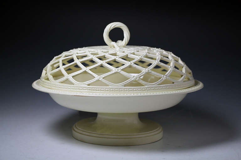 A rare antique period English creamware pottery shallow form chestnut dish and cover. 
The pierced work on the cover is exceptional and is probably the work of the famous Leeds Pottery in Yorkshire England. 
A large decorative piece with a very