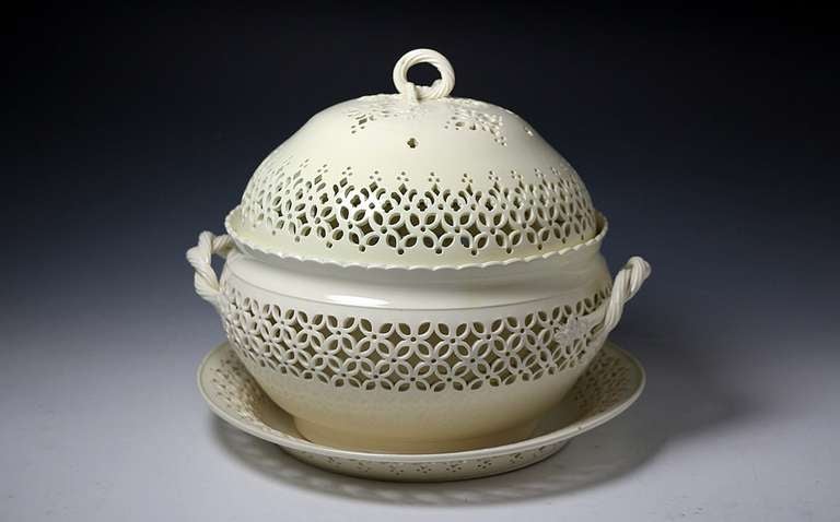 One of the finest examples of 18th century period creamware pottery produced by the famous Leeds Pottery in Yorkshire, the chestnut basket and stand. 
This iconic piece of plain undecorated creamware with its intricate hand pierced decoration is a